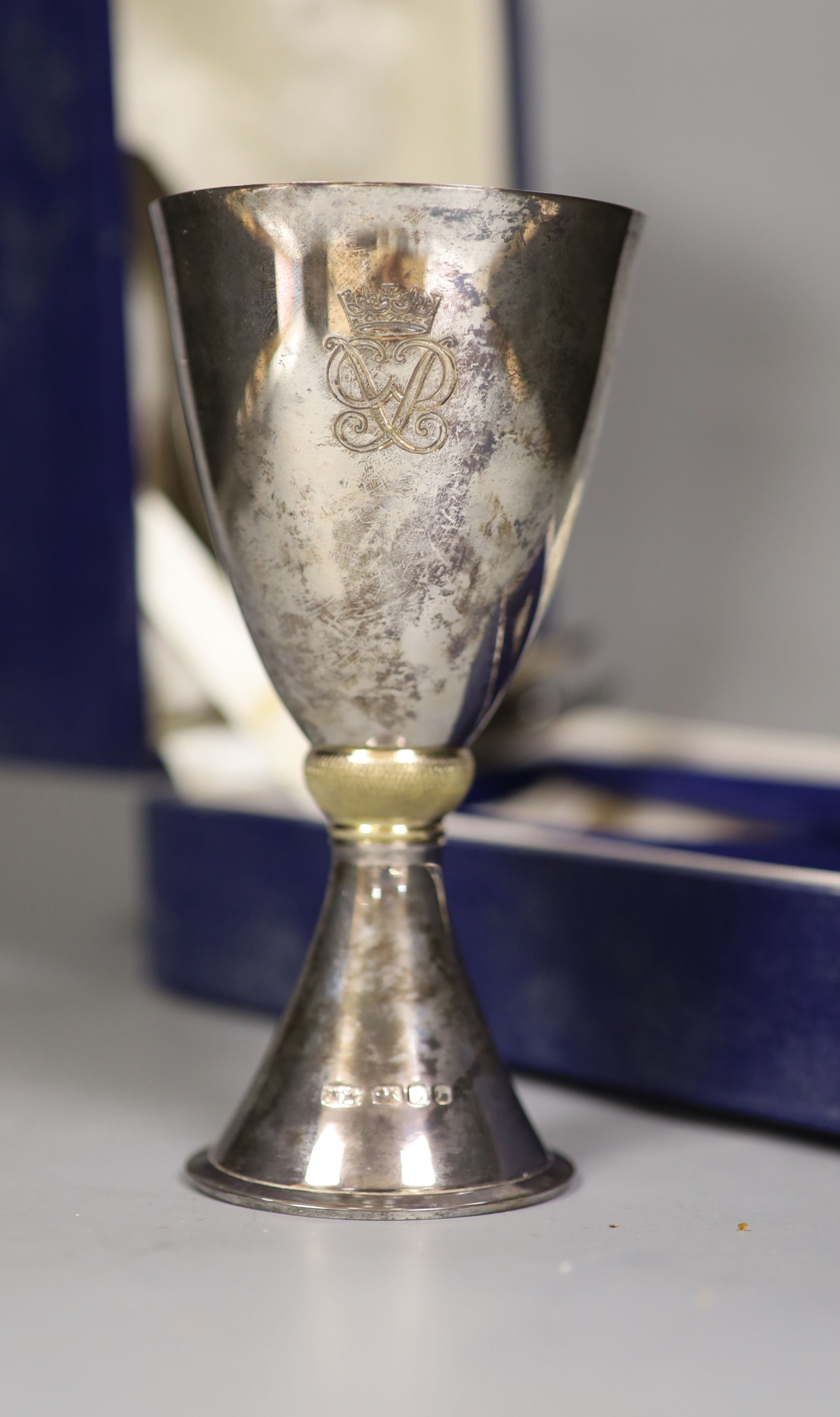 A Mappin and Webb silver and silver gilt goblet to commemorate “Silver Wedding Queen and Duke of Edinburgh 1947-1972” (London 1972), 14.4cm boxed together with Asprey silver ashtray with matchbox holder, gross 10oz.